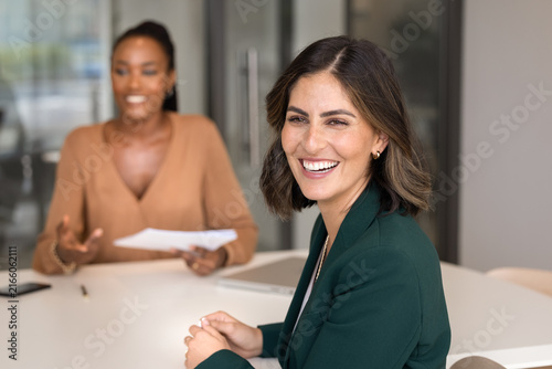 Portrait of confident businesswoman smiles at camera while attending job interview in modern office. Professionalism  positive communication between employer and candidate  career growth opportunities