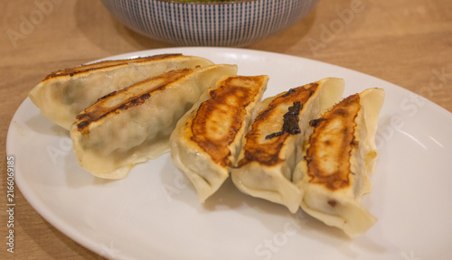 Принти на полотні Top down view of a plate of gyoza or fried dumplings