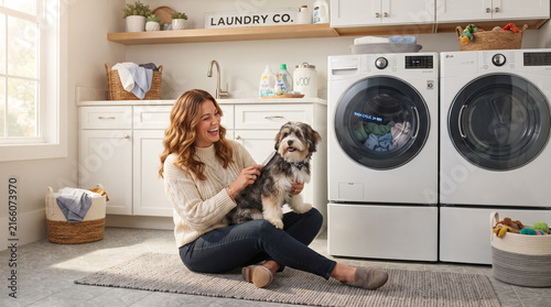 Smiling Woman Petting Cavalier King Charles Spaniel in Laundry Room