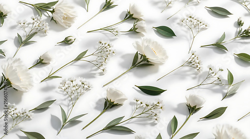Fresh botanical flat lay featuring crisp white blooming flowers and sharp green leaves on pure white background for modern wellness and beauty branding