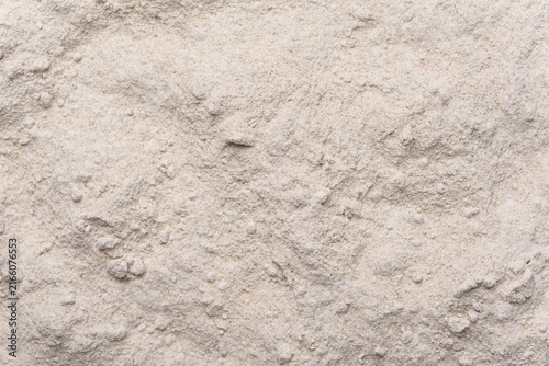 Close-up texture of organic rye flour, grey grain powder background, top view