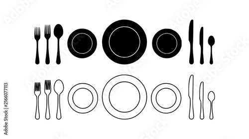 Dining utensils and plates set with flat lay arrangement featuring fork, knife, spoon, and dinner plate with glass and napkin