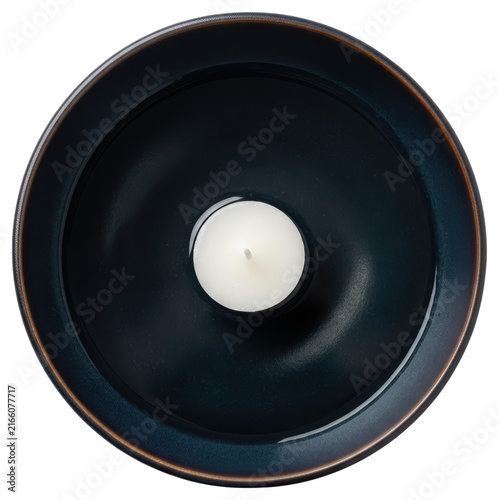 Minimalist white tea light candle in dark blue ceramic bowl on a transparent background