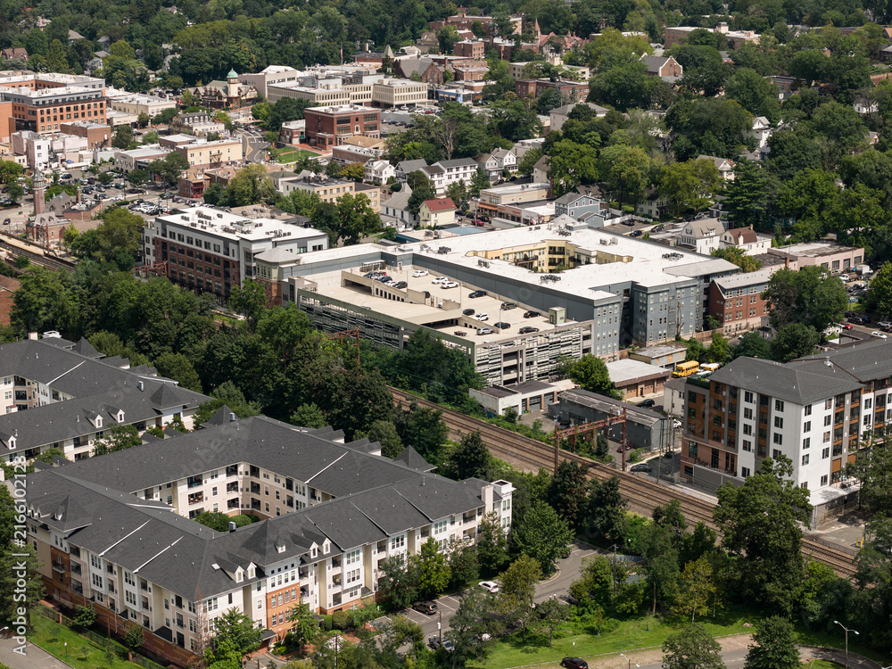 Fototapeta premium Aerial drone view of golf course fairways, nearby homes, and mature trees in Bayberry Park, New Rochelle, New York