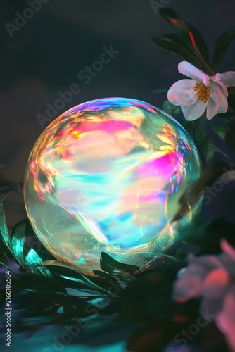 Glowing iridescent sphere surrounded by dark foliage and delicate flowers