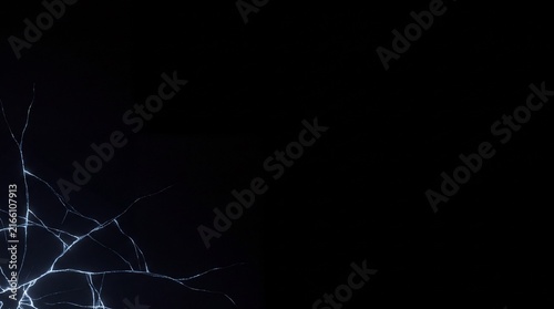 Cracked surface with glowing lines on black background