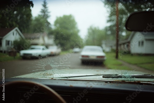 Broken windshield view of a street