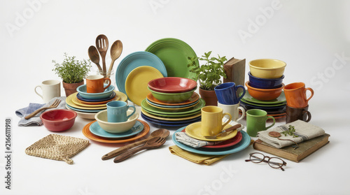 Colorful ceramic dishes and cups arranged with wooden utensils and potted herbs create vibrant co living community culture