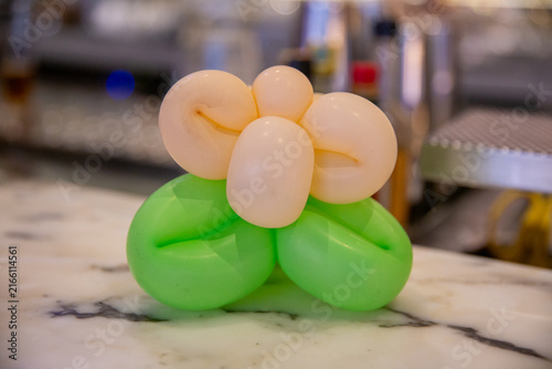 Foto Balloon animal flower art on marble counter.