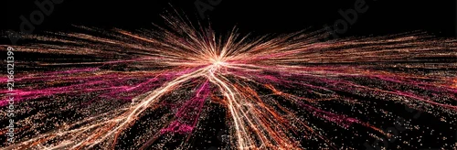 Obraz  z motywem Abstract digital art with radiating streaks of pink and orange particles on a black background