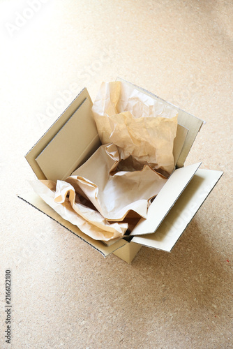 two cardboard postal packaging boxes standing on a floor