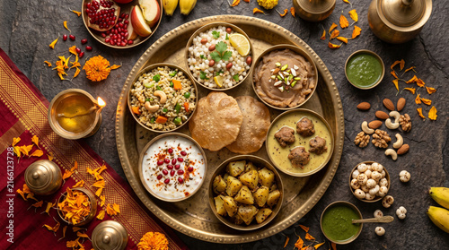 Traditional Indian festive food thali with curries, puri, and dry fruits