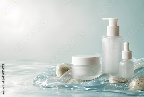 Cosmetic products arranged with stones and water