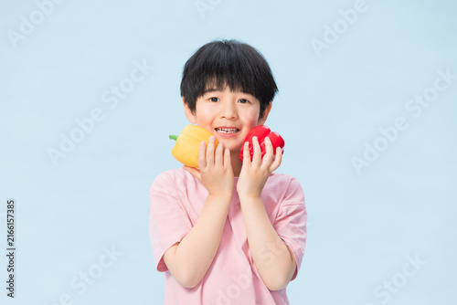 Cute Little Boy Holding Colorful Bell Peppers
