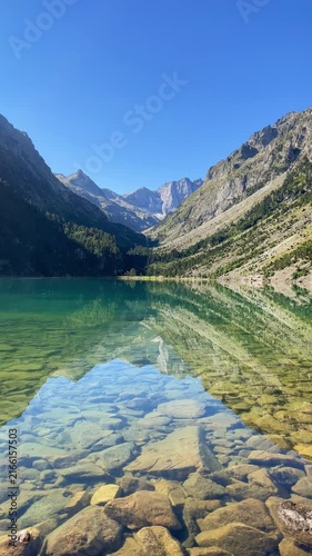 Crystal Clear Turquoise Mountain Lake with Rocks and Alpine Peaks Reflection, Nature and Serenity Concept, Gaube lake in French Pyrenees