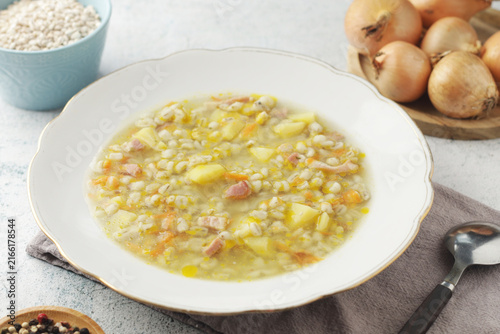 A plate with traditional Italian soup Zuppa d'Orzo served on the table