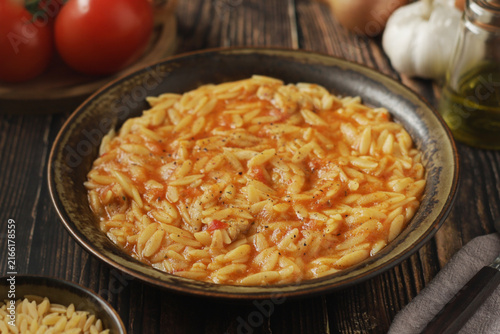 A bowl with traditional Greek soup Manestra with orzo pasta