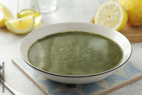 A bowl with traditional Greek spinach soup Spanakosoupa	