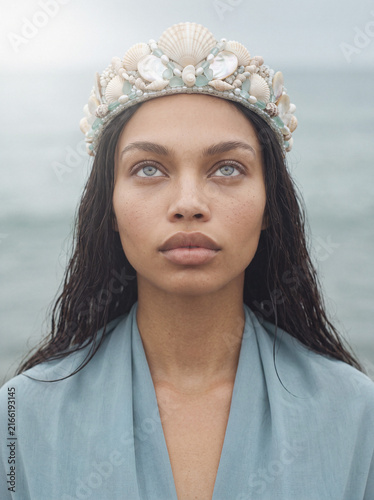 Woman wearing seashell crown, regal coastal mystical portrait