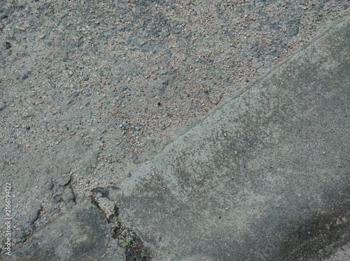 Fotografie Gravel and concrete surfaces with cracks and dark spots