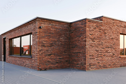Small commercial building constructed with reclaimed red brick