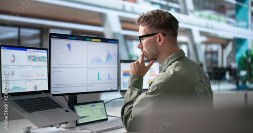 Data Analyst Focused On Financial Dashboard Using Laptop