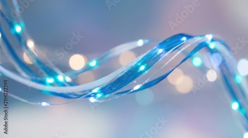 Close-up of blue LED string lights with glowing bulbs and twisting wire on soft blurred background