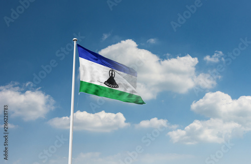 Fotografie Lesotho flag waving in beautiful sky.
