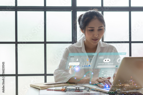 Business technology concept featuring a professional woman using a laptop with AI interface, data analytics dashboards and digital elements, representing artificial intelligence.