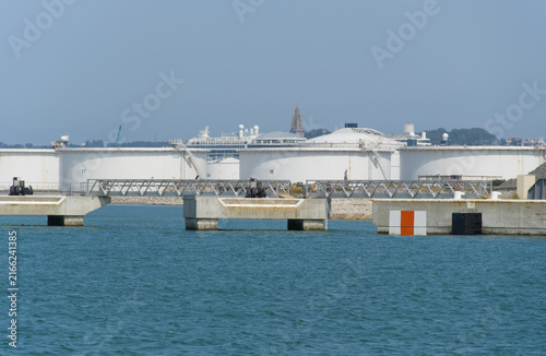 Canvastavla Port 2000 with oil storage tanks at French city of Le Havre on a sunny summer day