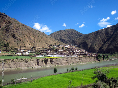 Photography Picturesque mountain village with river and green fields
