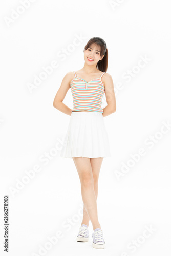 Fotografía Full length smiling young woman in striped camisole and white skirt on white bac