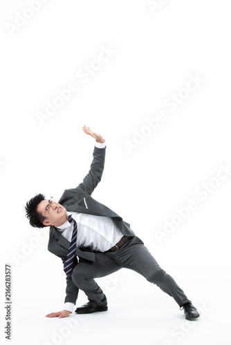 Stressed businessman crouching under pressure on white background