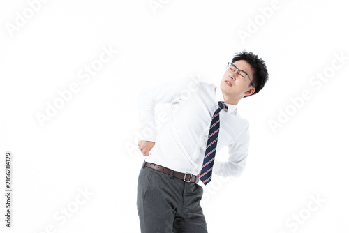 Businessman suffering from lower back pain isolated on white background