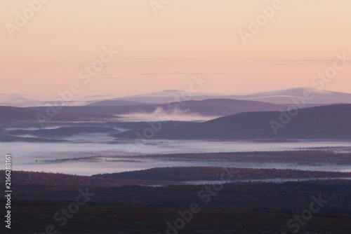 Morning fog over an endless mountain landscape in Finland