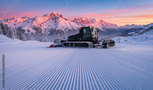  sleek black snow-cat grooming machine parked on a freshly groomed corduroy ski slope at dawn with mountain peaks bathed in pink alpine glow, Symmetrical corduroy snow track patterns
