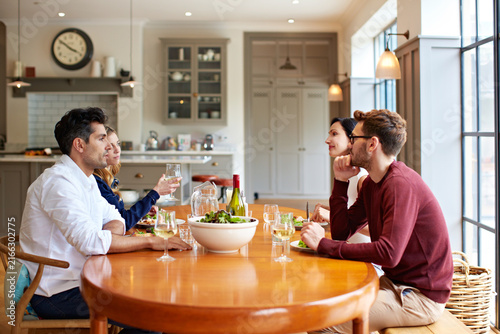 Bild auf Leinwand Home, wine and couple of friends for lunch, social reunion or bonding with food at dining table