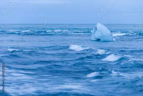 Ice floes lying on a black beach near Jokulsarlon glacier lagoon in Iceland
