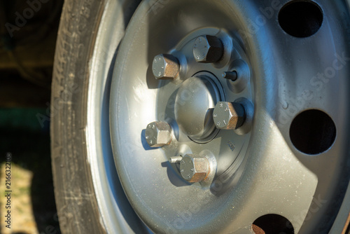Close view of a metal wheel rim showing bolts and details on a vehicle