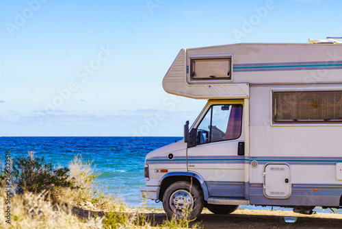Caravan recreational vehicle camping on sea shore.