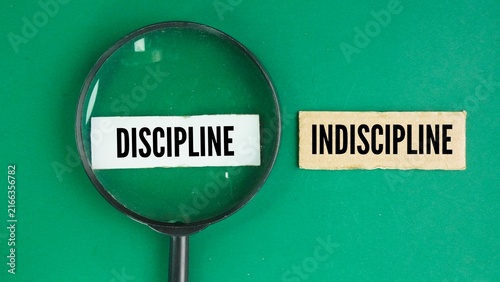 Magnifying glass with the words discipline and Indiscipline. choose a discipline. training that develops self-control, obedience, or order