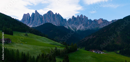Fotografie Majestic scenery of rough mountain ridge near grassy hills