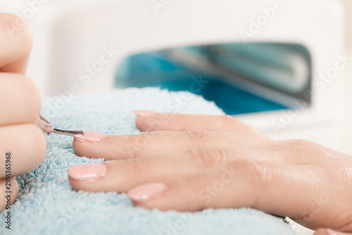 Woman in beauty salon getting manicure done.