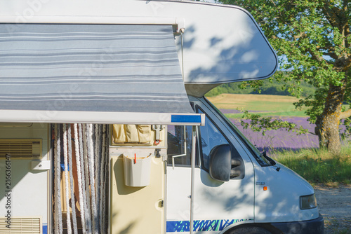 Camper with an awning extended, providing shade for outdoor relaxation
