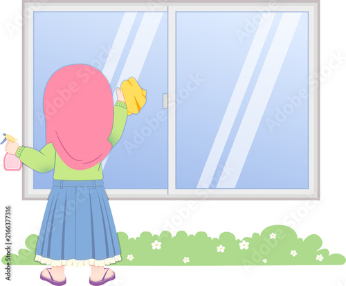 A young Muslim woman in a hijab cleaning a large glass window with a spray bottle and cloth outside