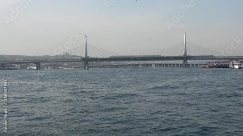 Istanbul, Turkey - February 29, 2024: Zoom in Golden Horn Metro Bridge view in winter
