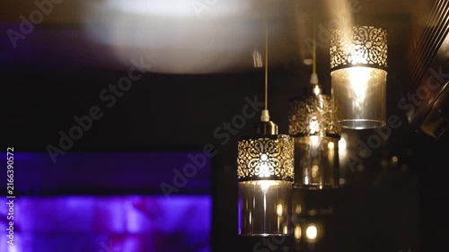 Soft glowing bokeh lights in warm gold deep purple against dark background. Blurred motion creates dreamy, atmospheric mood. Ideal for background, mood design, ambient visual projects