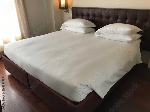 Obraz na plátně White double bed in a modern Florence hotel room in Hotel room, Florence, Italy