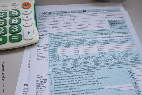US Individual Income Tax Return Form 1040 with Calculator and Pen for Annual Tax Filing Concept