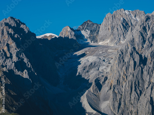 Photography Landscape with rocky ridges and snowcapped mountains